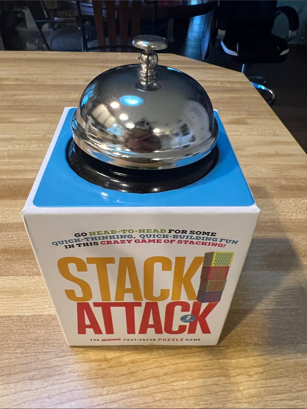 #3416**Stack Attack Game Box with Silver Service Bell - White, Blue, Yellow, Red